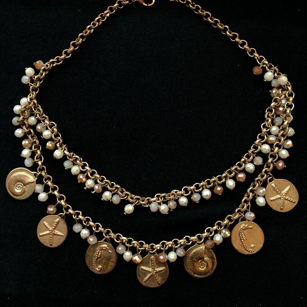 Rose gold necklace/earrings with beach accents.